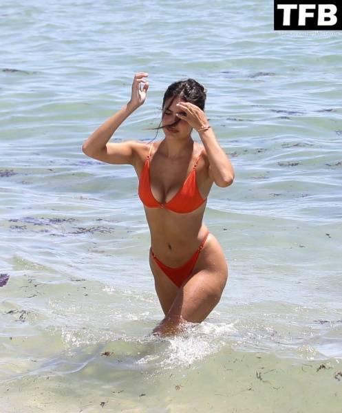 Tao Wickrath Stuns in Small Orange Bikini on the Beach in Miami - county Miami on modelfansclub.com